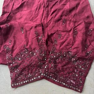 Burgundy pants with silver sequin embellishments on the hem elastic waistband